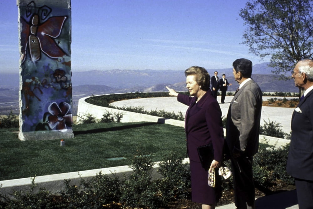 Photo print of Ronald Reagan, Margaret Thatcher, and Denis Thatcher with a piece of the Berlin Wall.