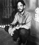 Raul Julia crouching in a prison photo print, 8x10 and 16x20 options