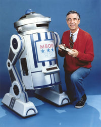 Mister Rogers holding remote control photo print in red sweater.