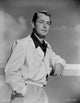 Alan Ladd leaning on a fence in a glossy suit black and white portrait photo print.