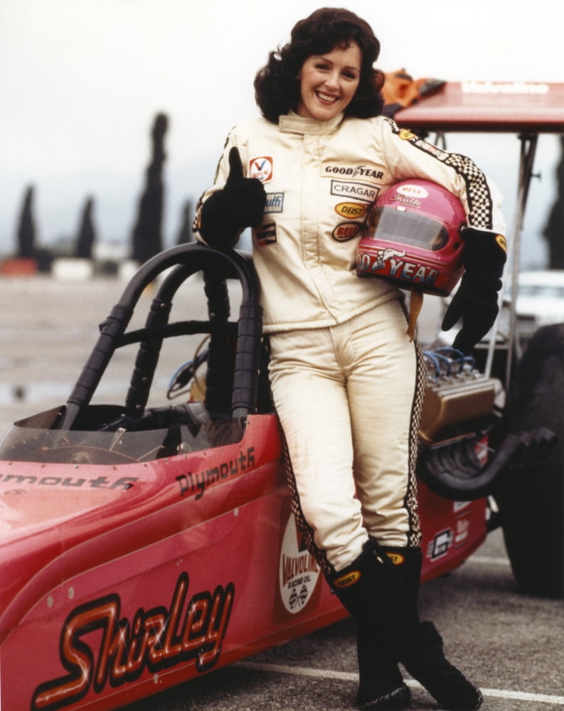 Bonnie Bedelia posing in car racing outfit with helmet photo print.