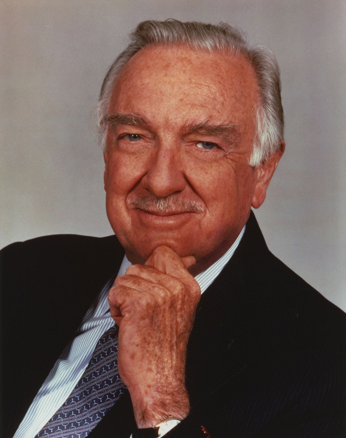 Walter Cronkite rubbing chin with hand photo print